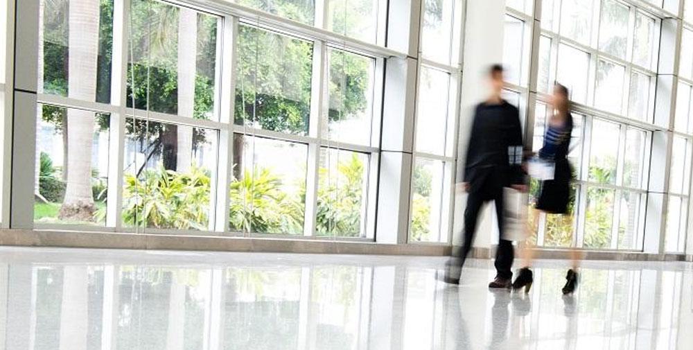 Business people walking in open well lit large room