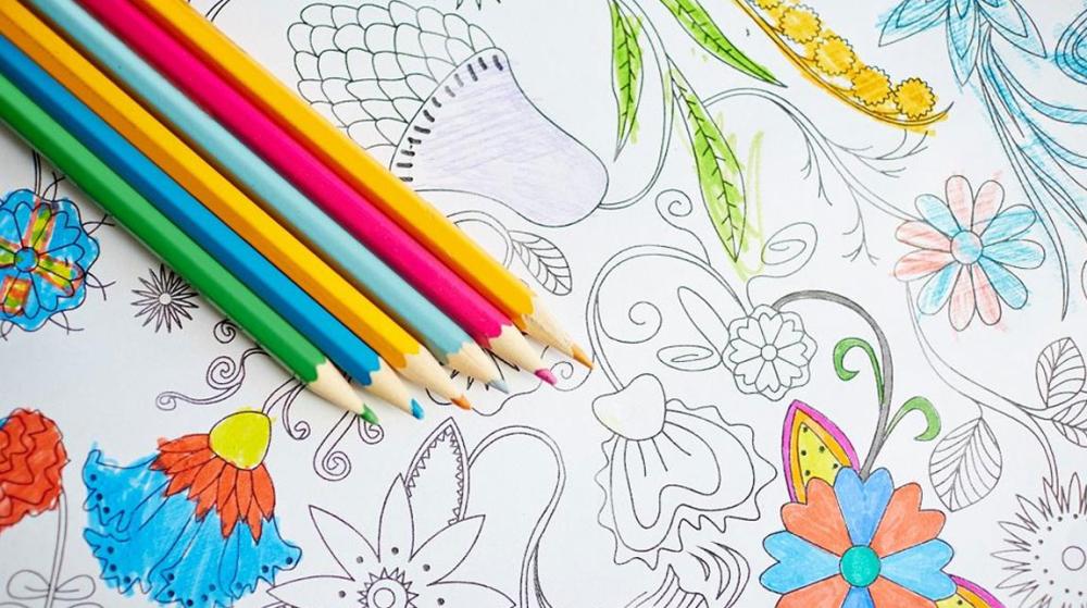 Creative flatlay with coloured pencils and drawing