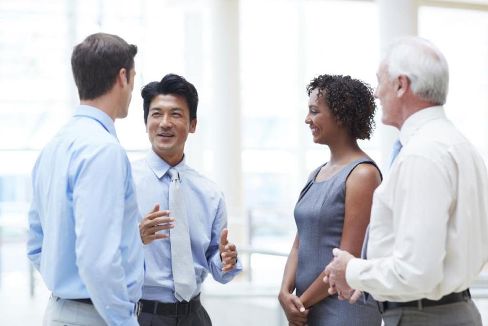 4 male and female work colleagues having a chat