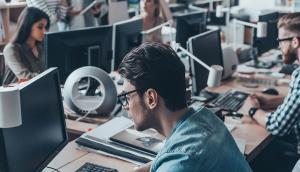 IT office with workers on computers