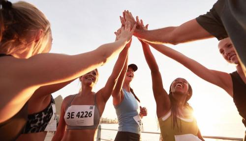 Happy young people on beach high fiving
