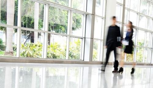 Business people walking in open well lit large room
