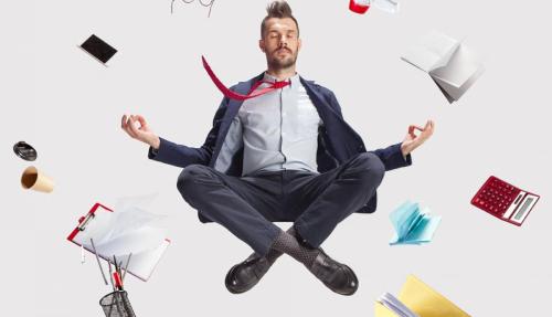 Funny man in suit cross-legged floating like a meditation with objects around him