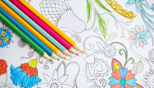 Creative flatlay with coloured pencils and drawing