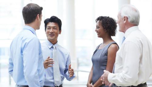 4 male and female work colleagues having a chat
