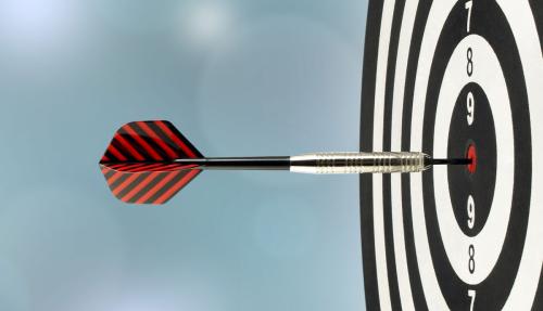 Dartboard sideon with dart hitting bullseye