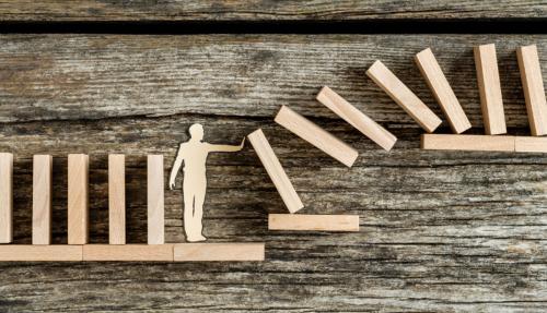 Wooden blocks stacked falling over
