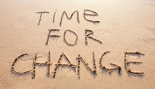 Time for change written in sand