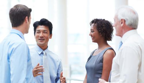Diverse group of 4 corporate professionals having a chat