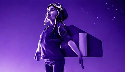 Child with wings pretending takeoff  purple background