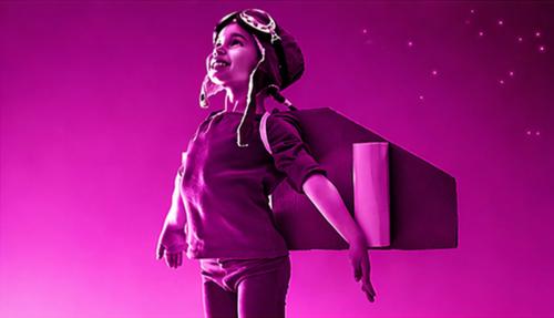 Child with wings pretending takeoff  light purple background