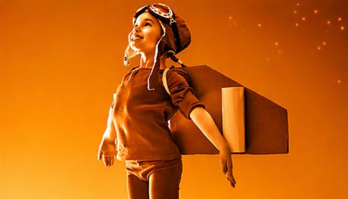 Child with wings pretending takeoff dull orange background