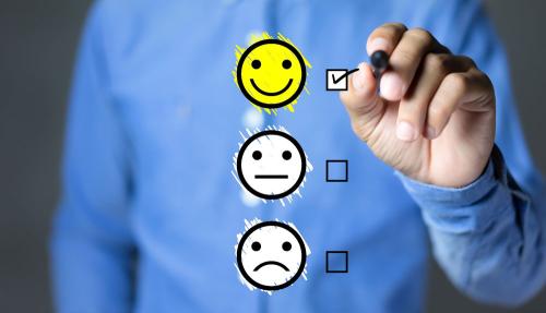 Man drawing smiley faces