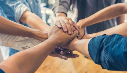 Closeup team hands together
