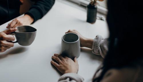 Man and woman having deep conversation over coffee