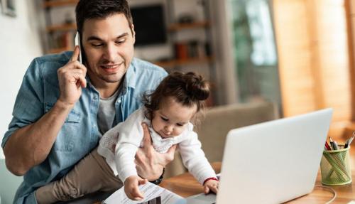 Man with child at home office laptop